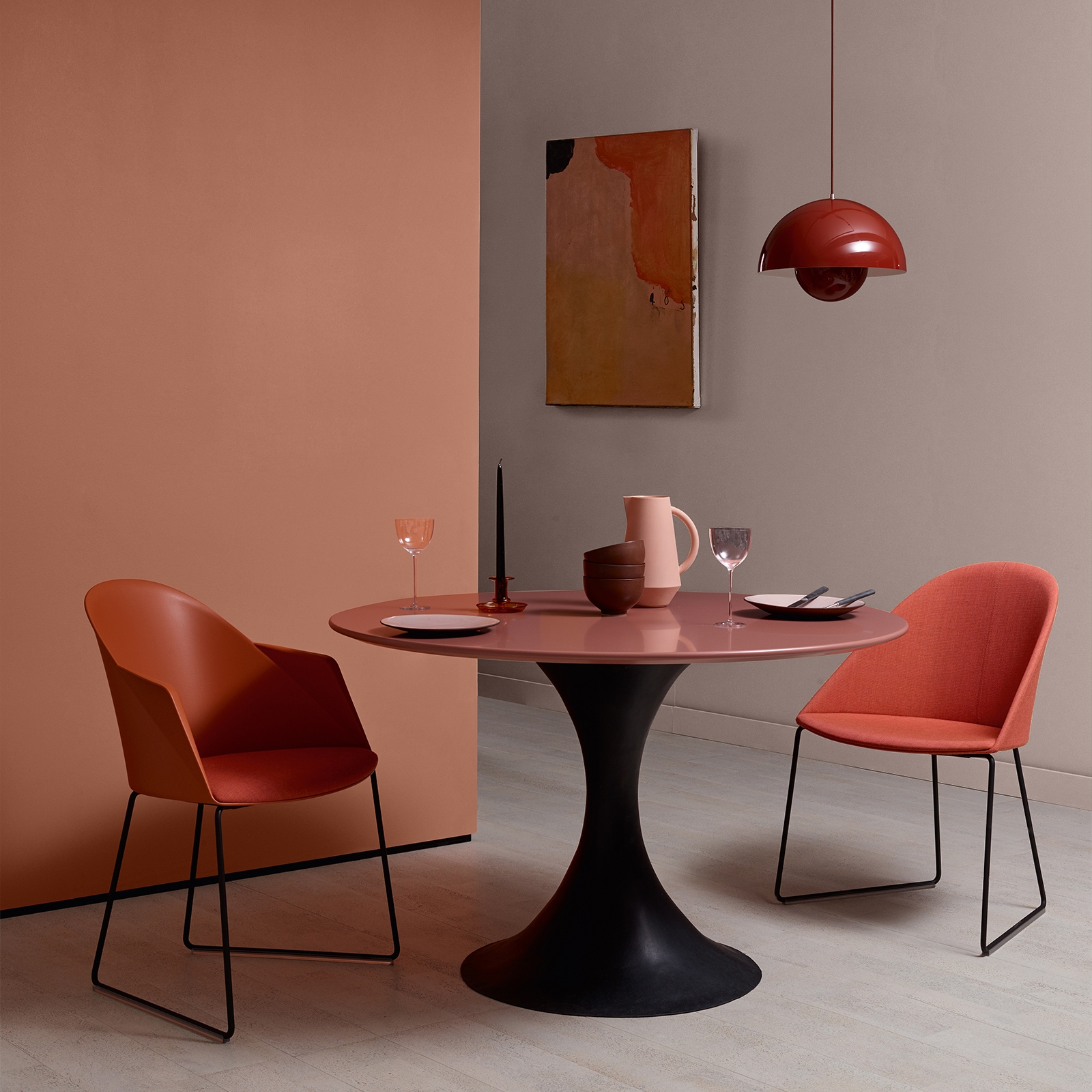 A warm orange accent wall brings colour to a modern dining area