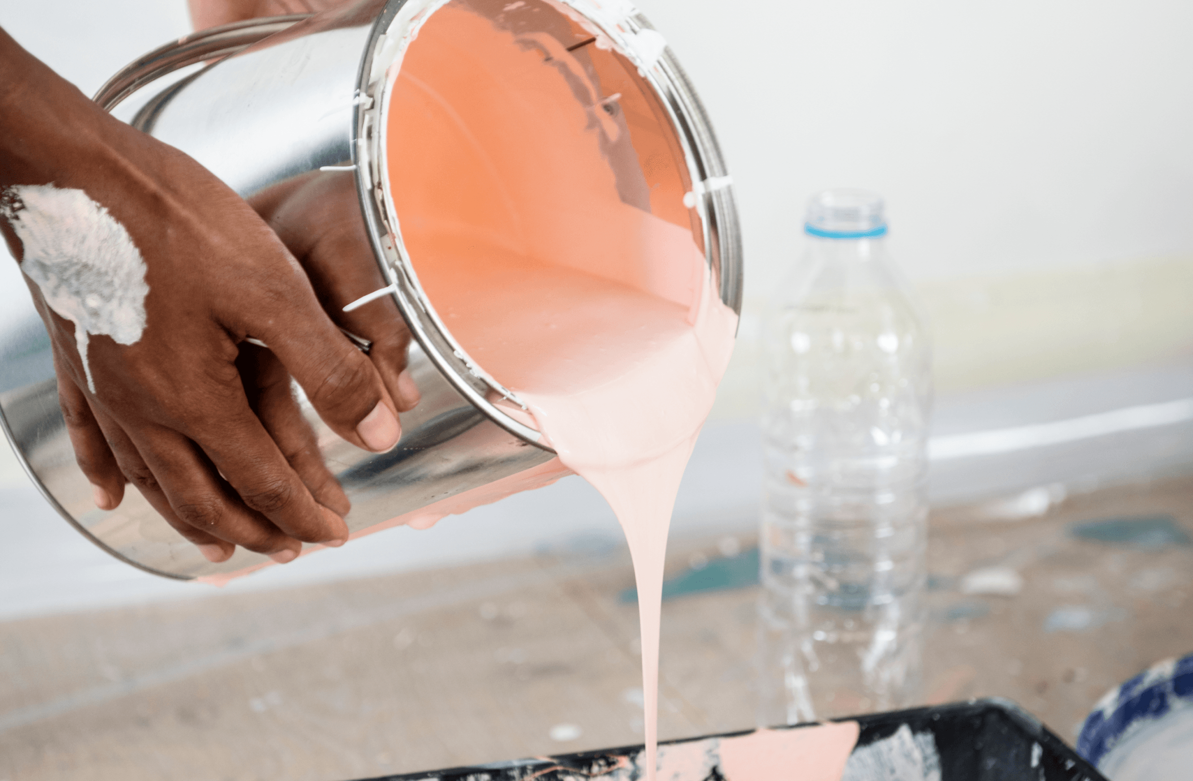 Paint being poured from a tin